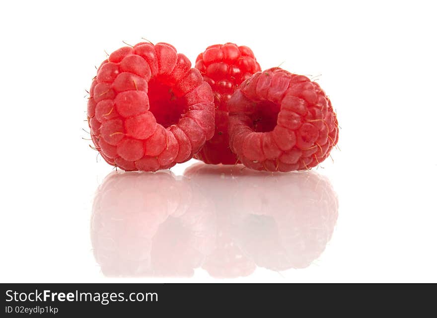 Red raspberry with reflection isolated on white