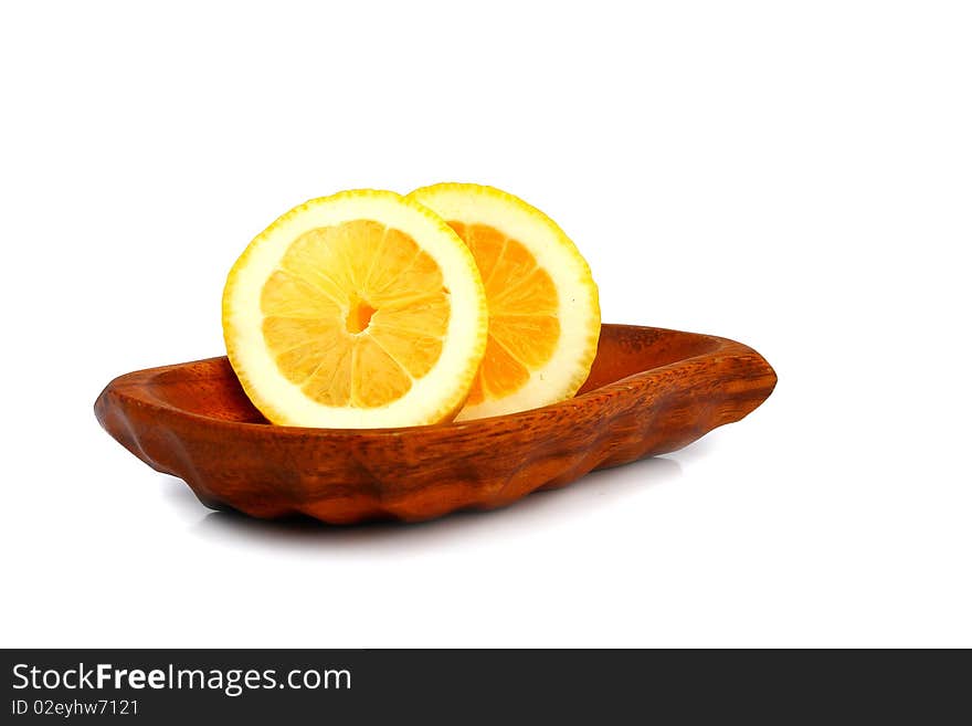 Slices of lemon on a wooden plate. Slices of lemon on a wooden plate