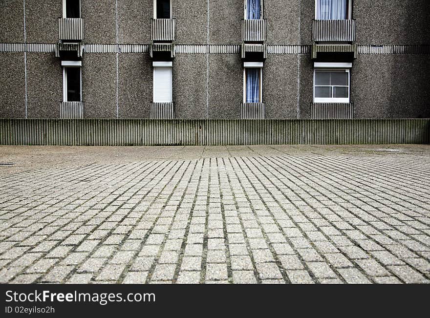 A grey and drab section of an urban social housing complex