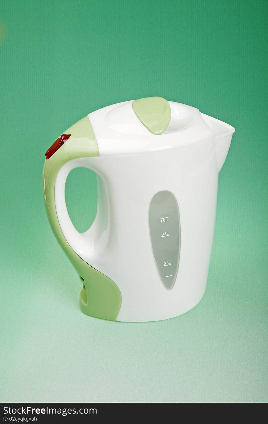 Electric kettle on green background