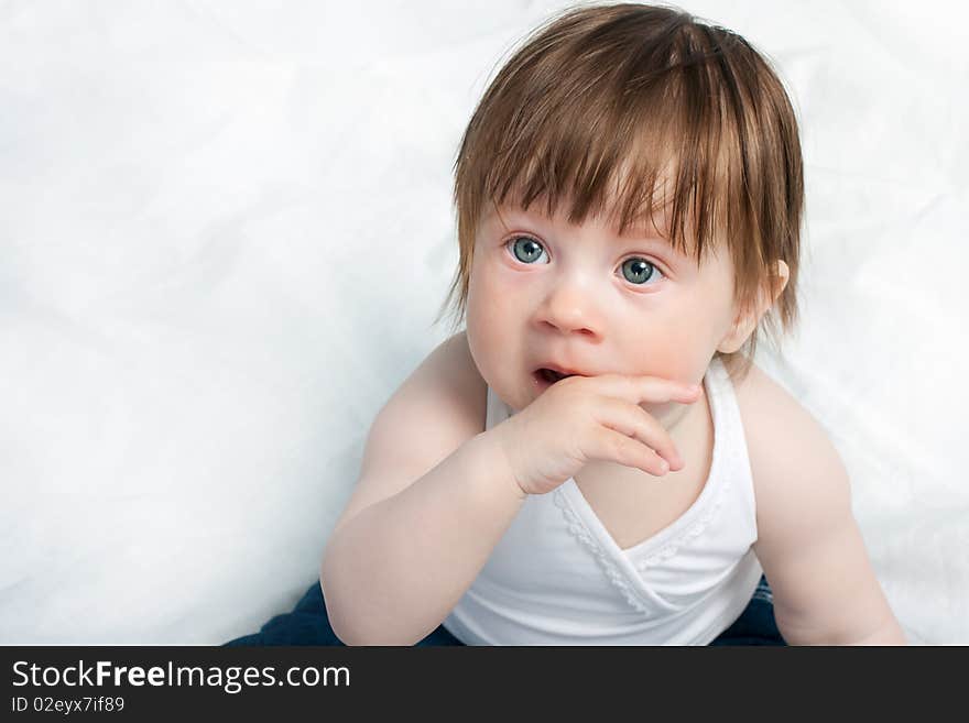 Little baby girl playing on the bed. Little baby girl playing on the bed