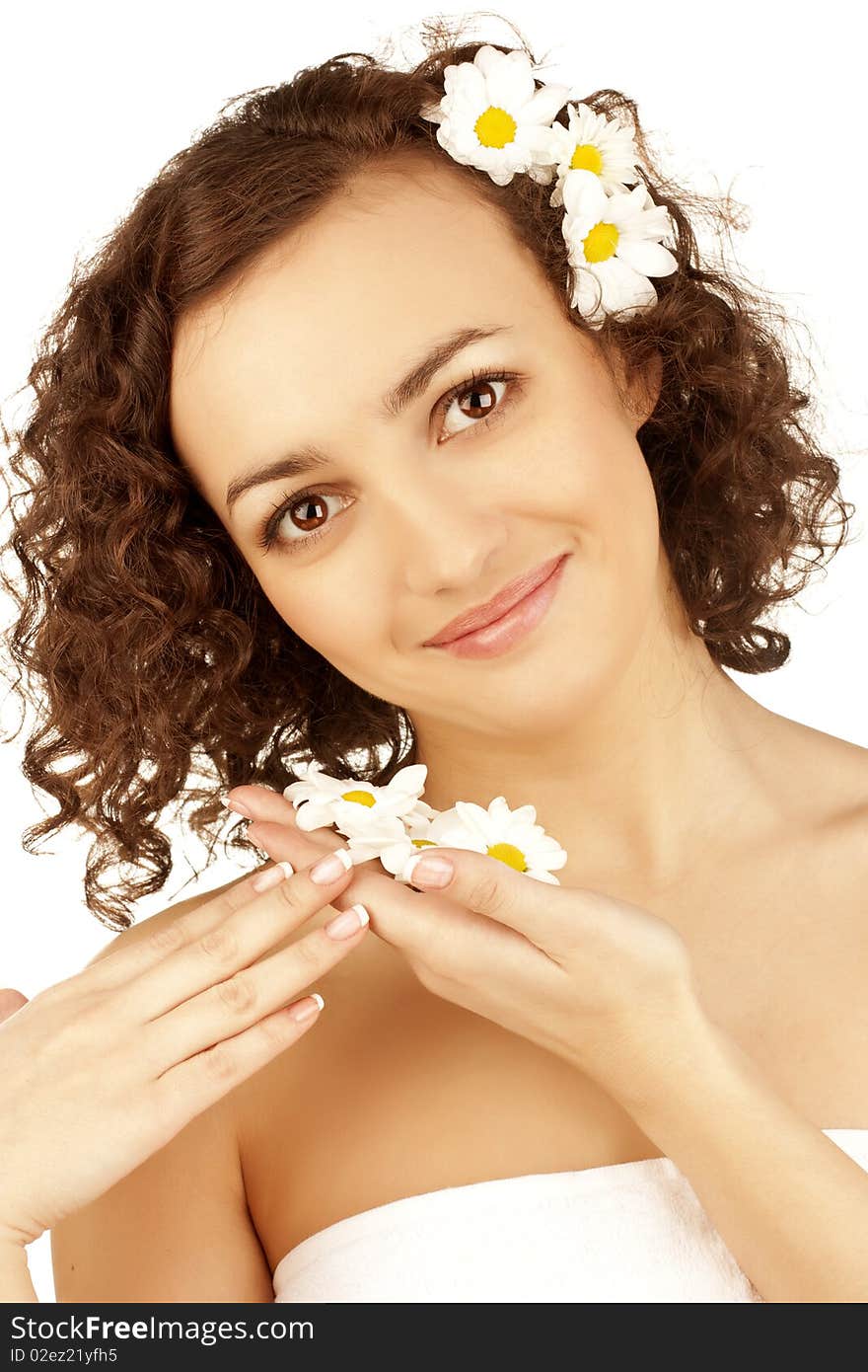 Beautiful woman with camomile flower on white background