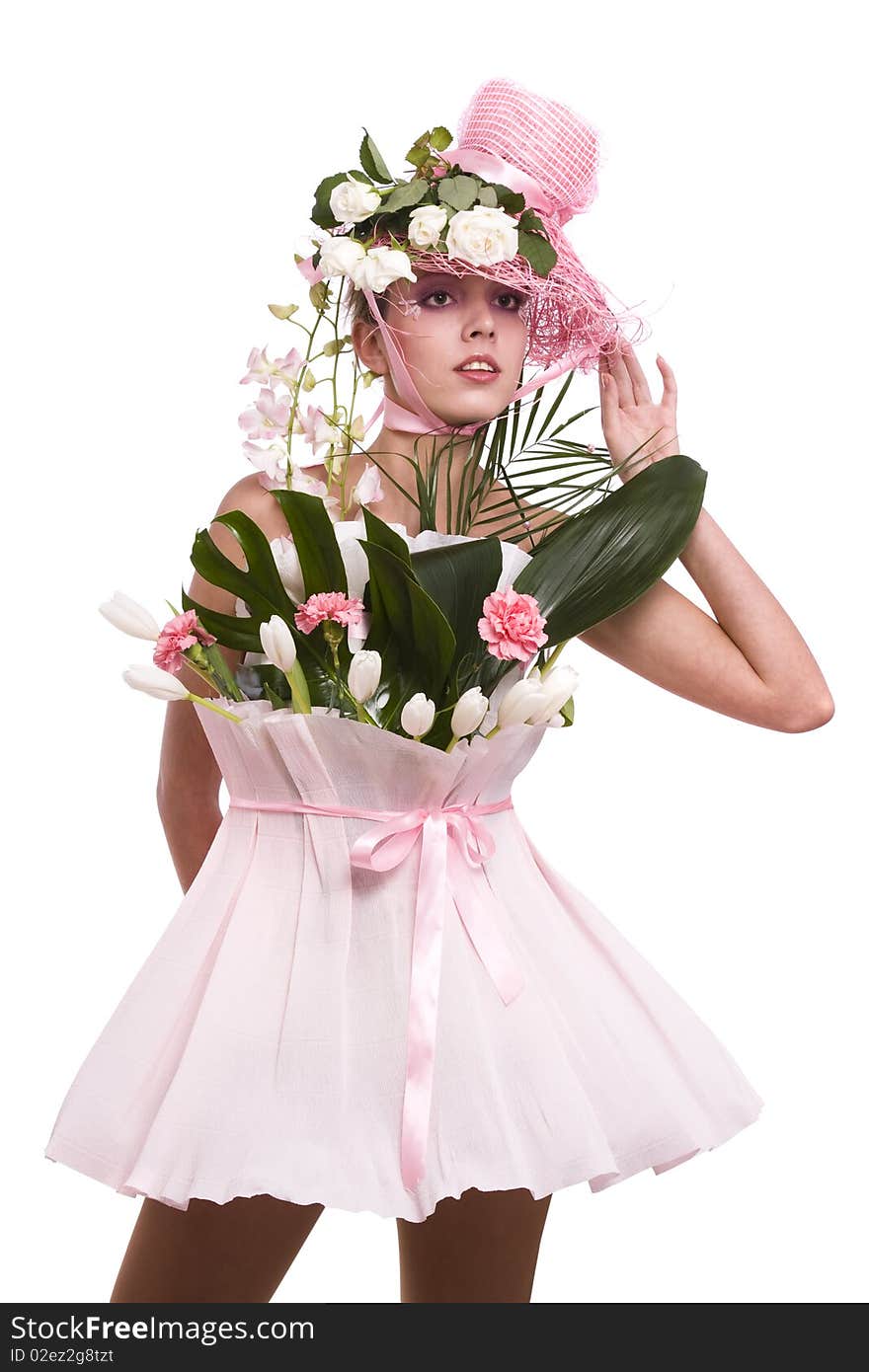 Fashion woman is bouquet of flowers. Elegant model with roses in her hat and and with tulips, carnation, orchids dress from wrapping. Fashion woman is bouquet of flowers. Elegant model with roses in her hat and and with tulips, carnation, orchids dress from wrapping.