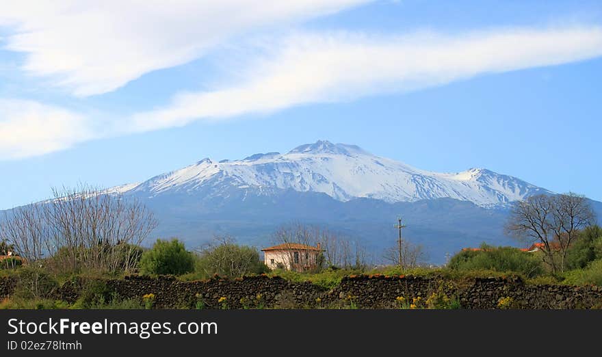 Photo of view on little house and mountain in background. Photo of view on little house and mountain in background