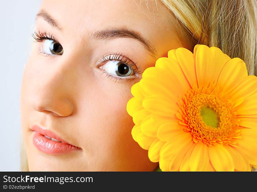 Young woman with a flower. Over white background