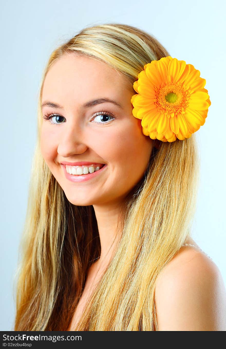 Sensual portrait of beautiful young blond woman with flower. Isolated on white background. Sensual portrait of beautiful young blond woman with flower. Isolated on white background