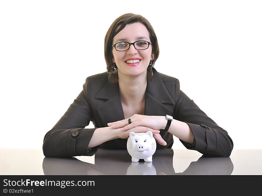 Young business woman iosolated on white putting coins money in piggy bank and representing concept of saving and smart spending money. Young business woman iosolated on white putting coins money in piggy bank and representing concept of saving and smart spending money