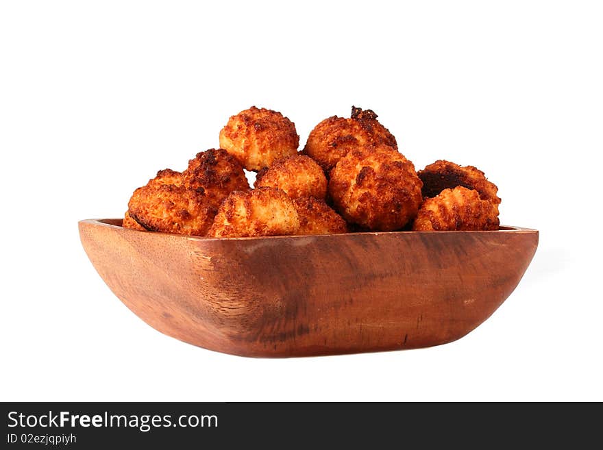 Almond cookies in a wooden plate on a white background. Almond cookies in a wooden plate on a white background.