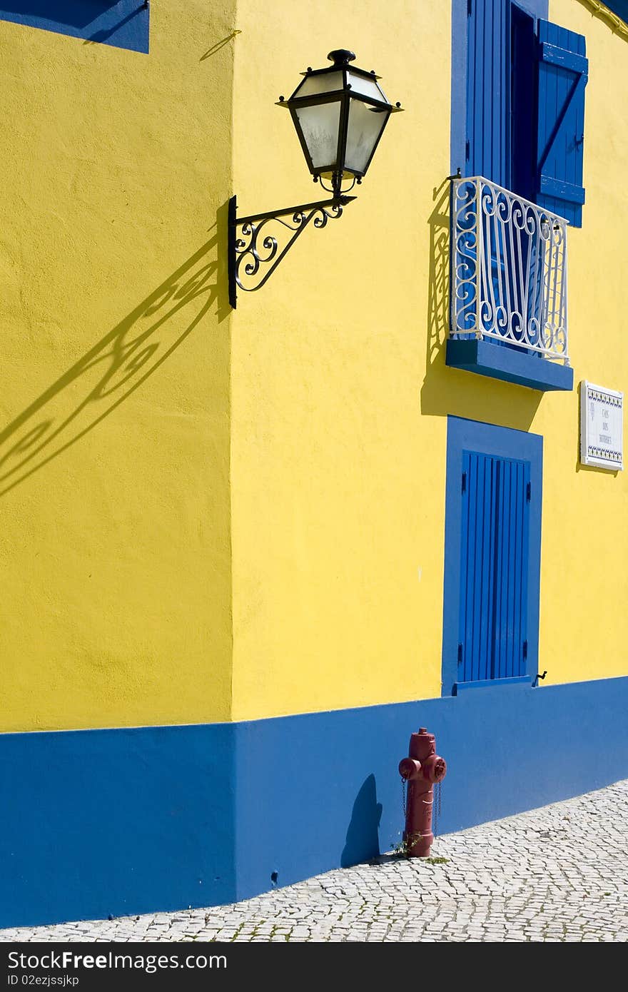 Detail of old houses facade in yellow and blue