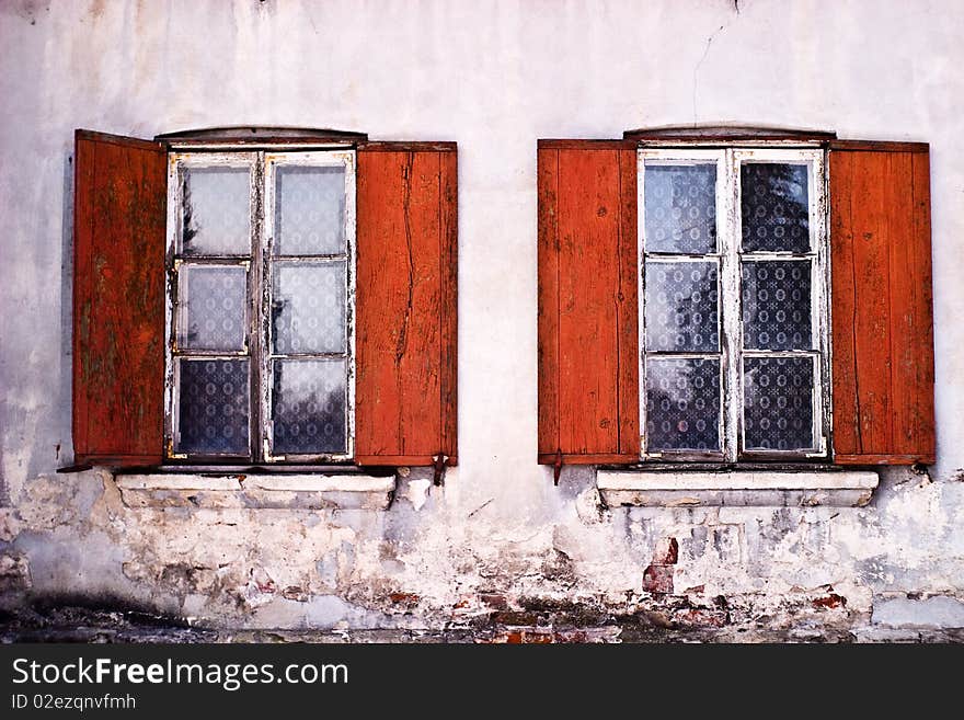 Two old windows, concrete wall and split glass