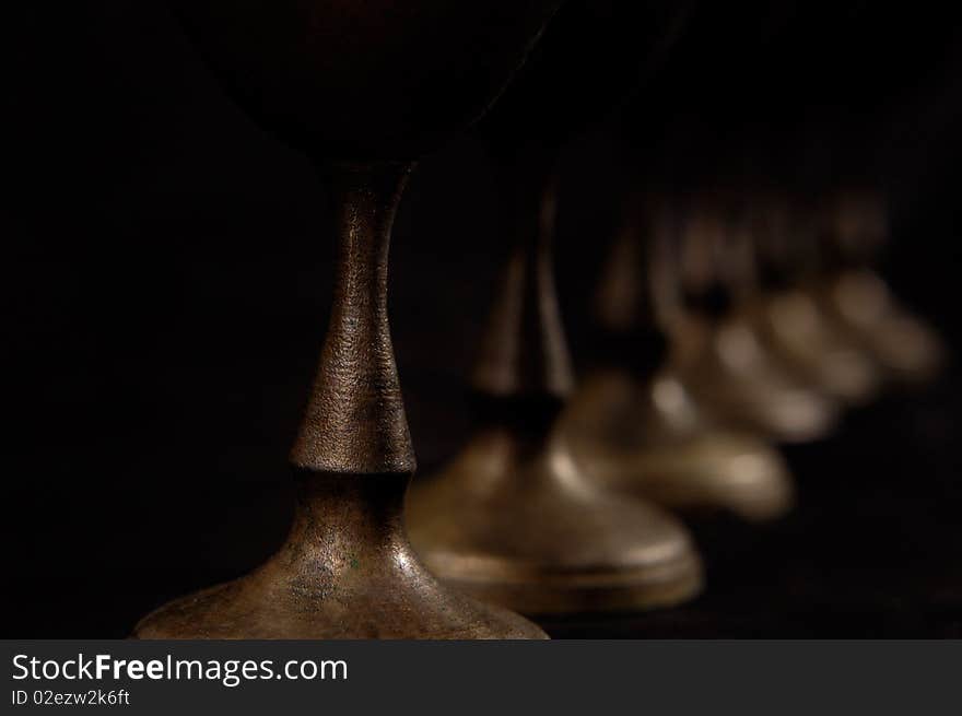 Antique decorative vintage silver stemware abstract close-up on black background. Antique decorative vintage silver stemware abstract close-up on black background