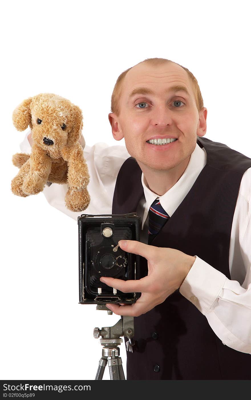 Photographer keeps toy smiles peers into eye and takes pictures old camera. Photographer keeps toy smiles peers into eye and takes pictures old camera