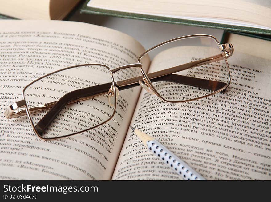 An open book and reading glasses closeup. An open book and reading glasses closeup