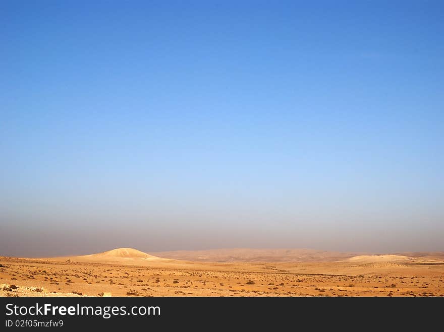 Fragment of Negev desert with mountains on a distance shot. Fragment of Negev desert with mountains on a distance shot