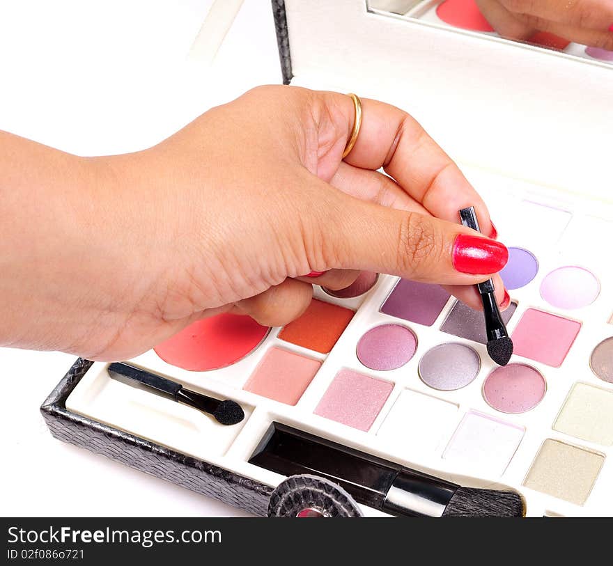 Makeup artist hand chosing the right shade. Makeup artist hand chosing the right shade.