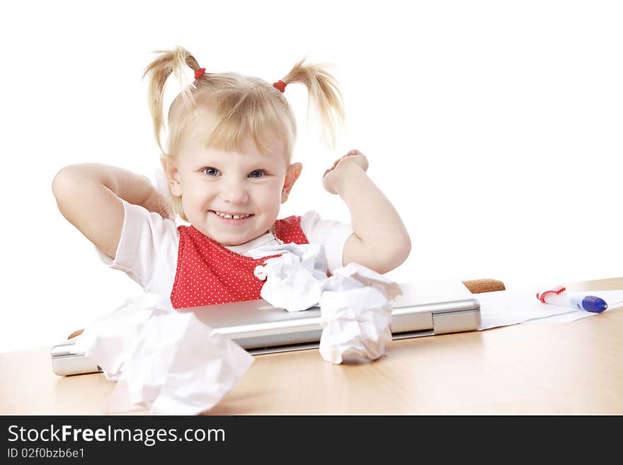 Child throwing crampled sheets of paper at the table