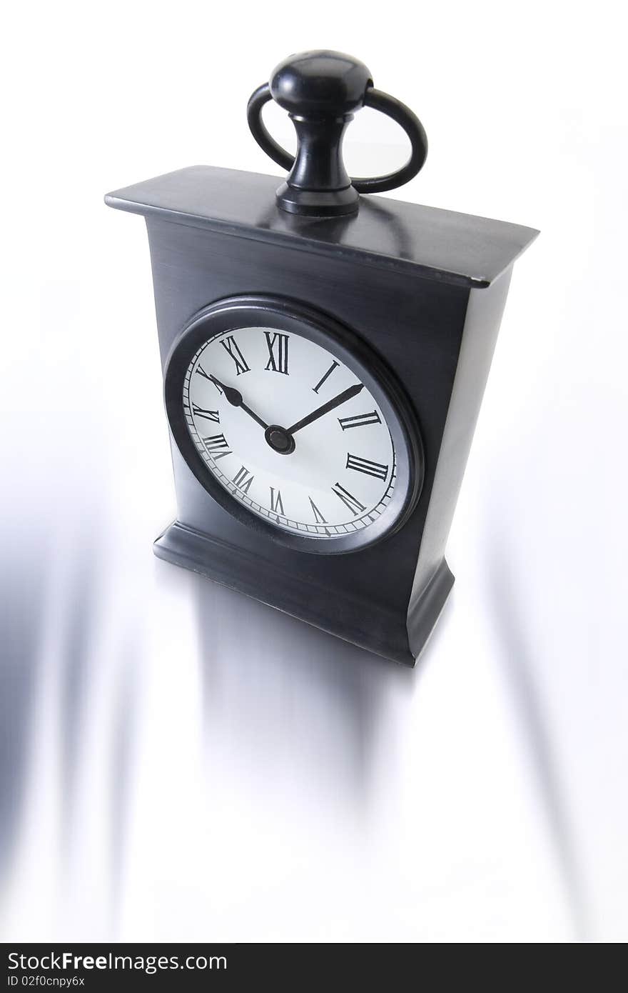 Old style alarm clock on white background