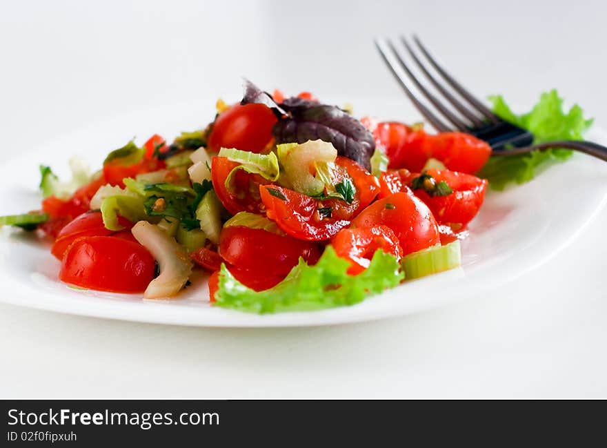 Fresh tasty tomato salad with celery and herbs