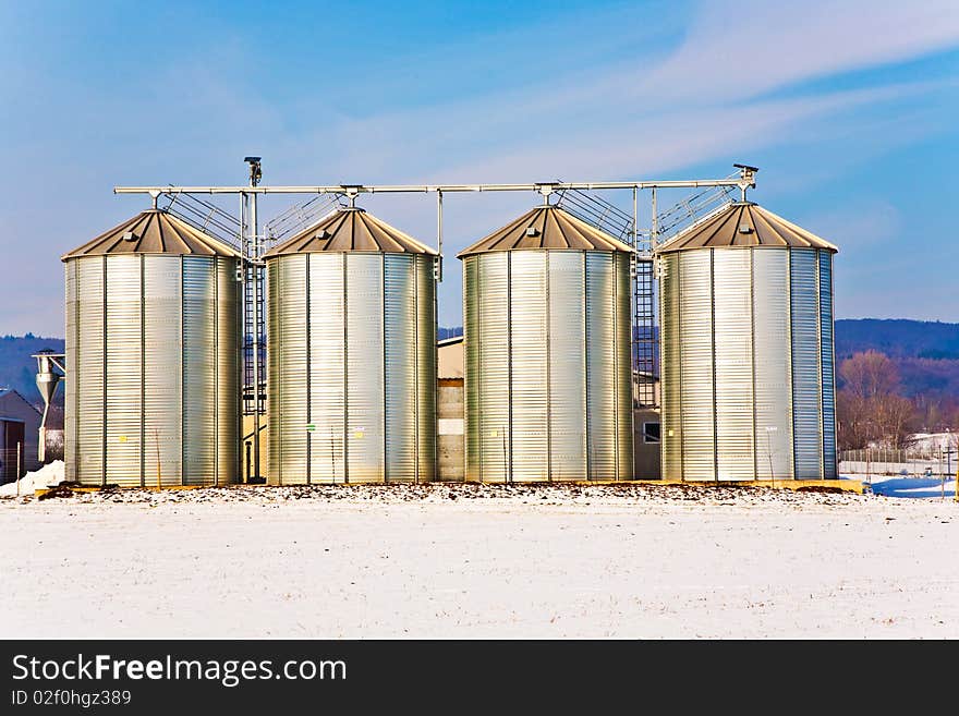 Silo In Winter With Snow And Blue Sky