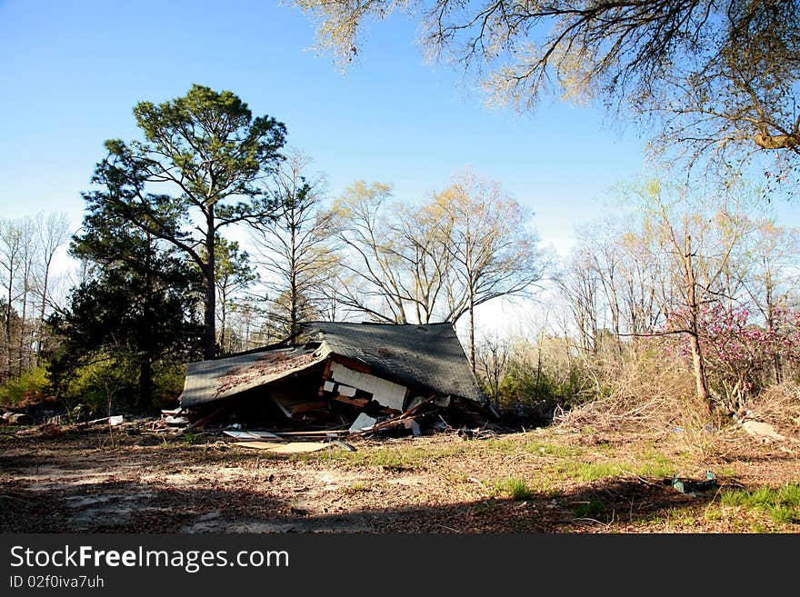 A home in the country that has collapsed down on itself. A home in the country that has collapsed down on itself.