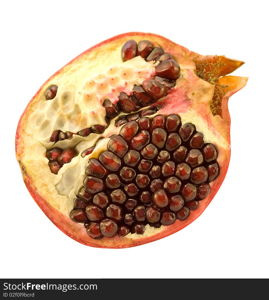 Half of pomegranate with grains on white