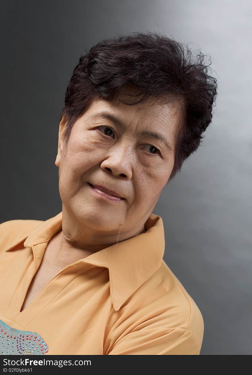 Portrait of an asian woman against grey background. Portrait of an asian woman against grey background