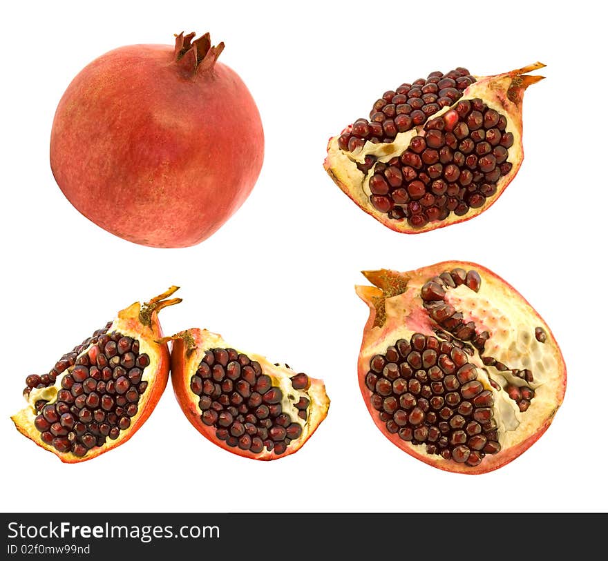 Set of pomegranates with grains on white