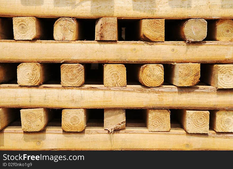 Square wood material piled up outside. Square wood material piled up outside.