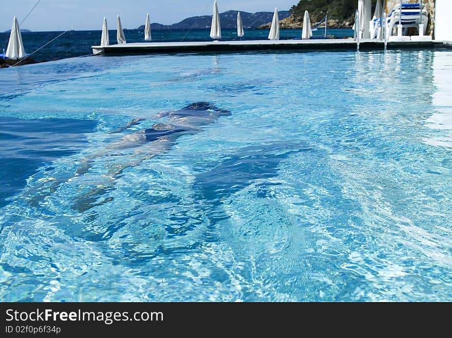 Woman swimming in the blue water