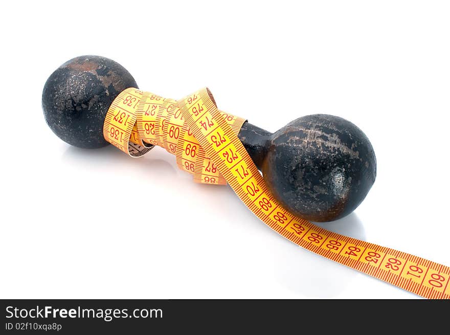 Dumbbell and tape-line on  white background. Fitness concept. Dumbbell and tape-line on  white background. Fitness concept.