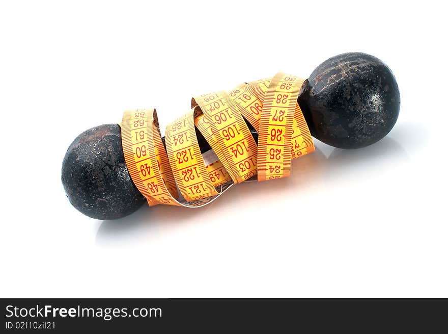 Dumbbell and tape-line on  white background. Fitness concept. Dumbbell and tape-line on  white background. Fitness concept.