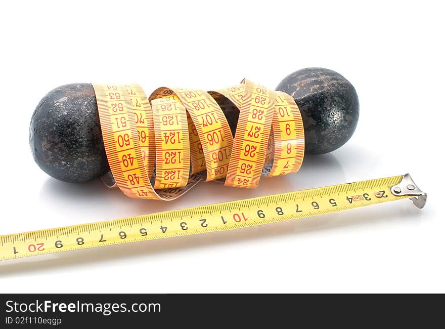 Dumbbell and retractable steel tape  on  white background. Fitness concept.