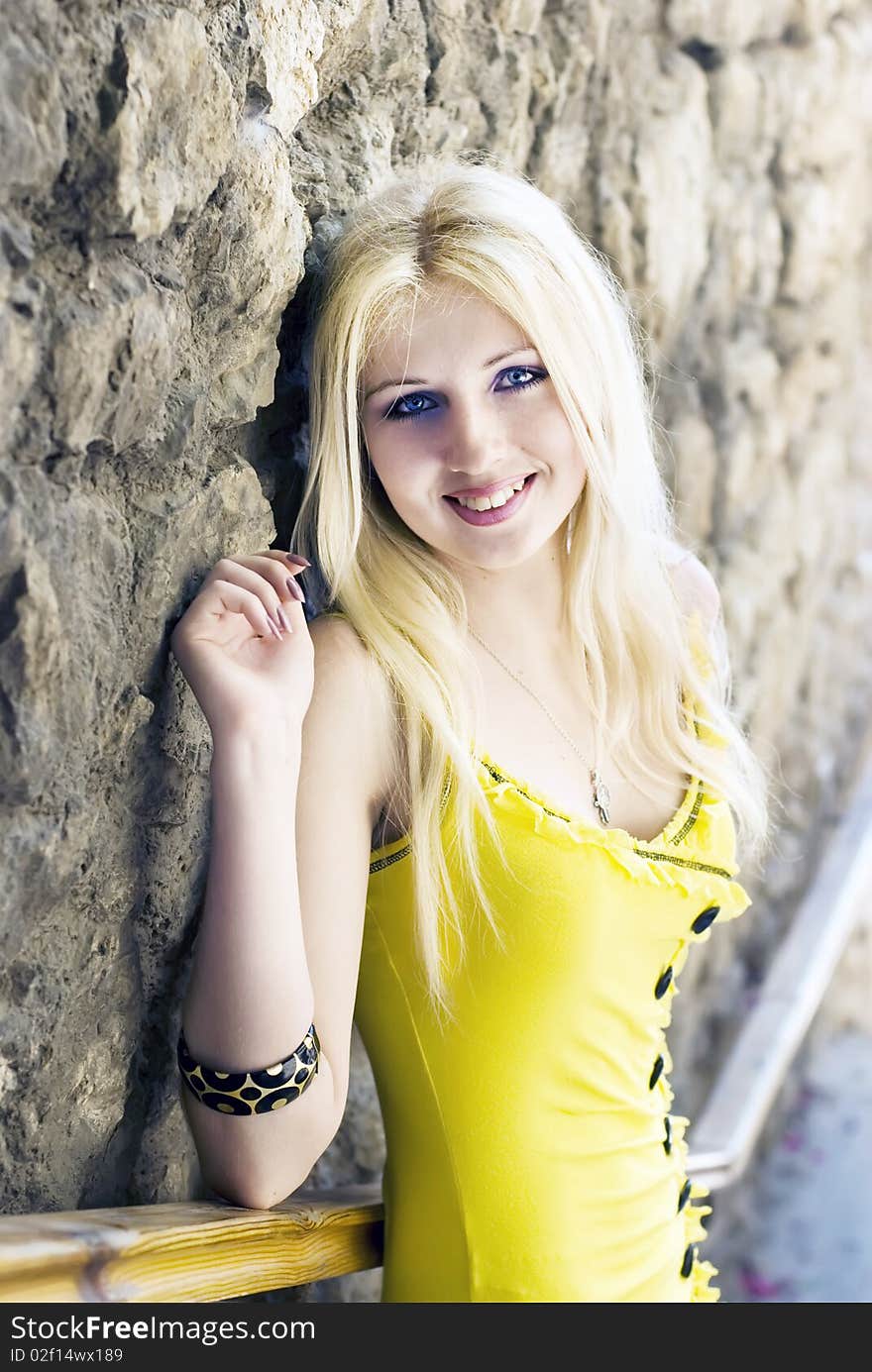 Beautiful blond girl in a yellow dress