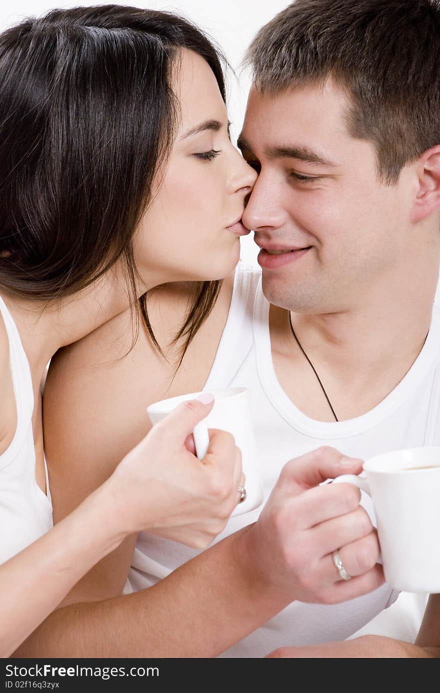 Young couple having breakfast in bed.