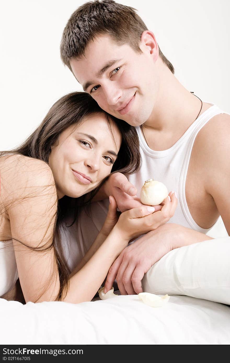 A young couple hugging in bed