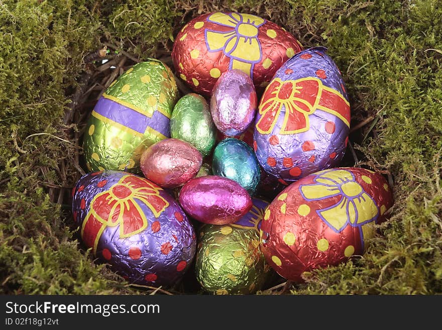 Colored  Eggs In Bird Nest Over White