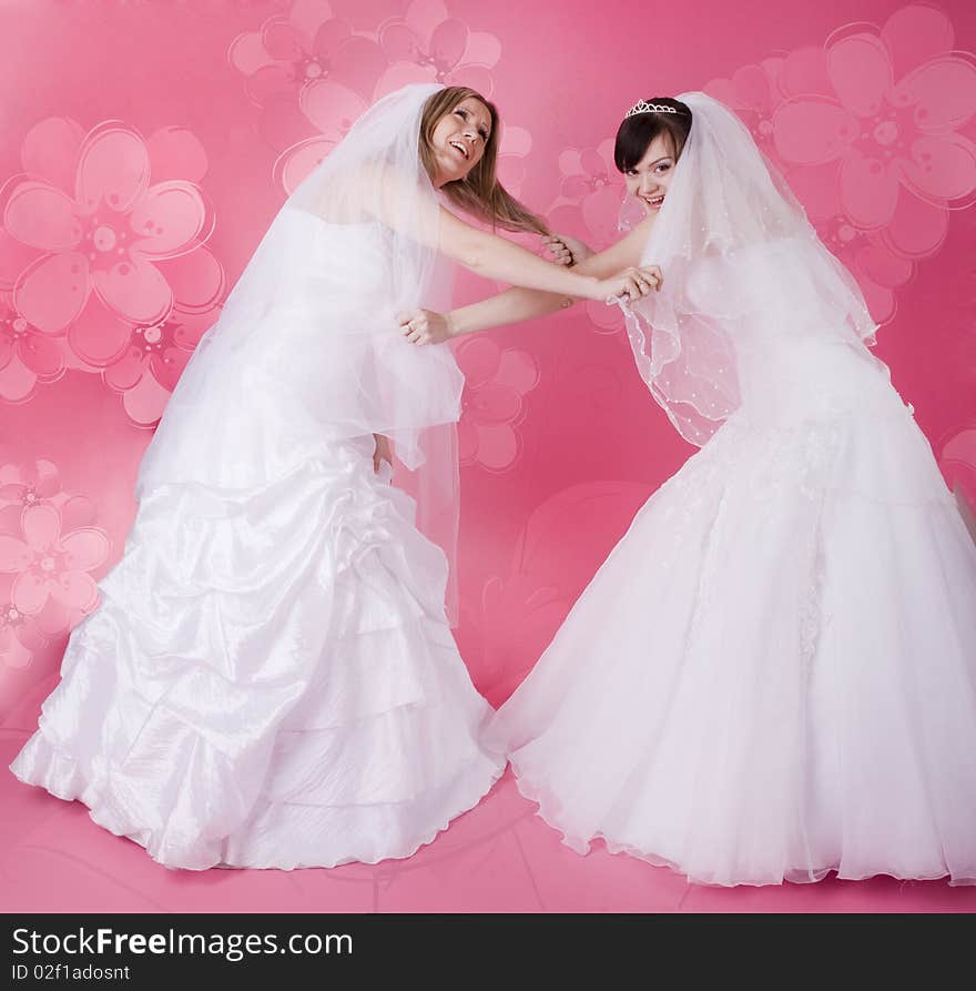 Two happy bride on a pink background