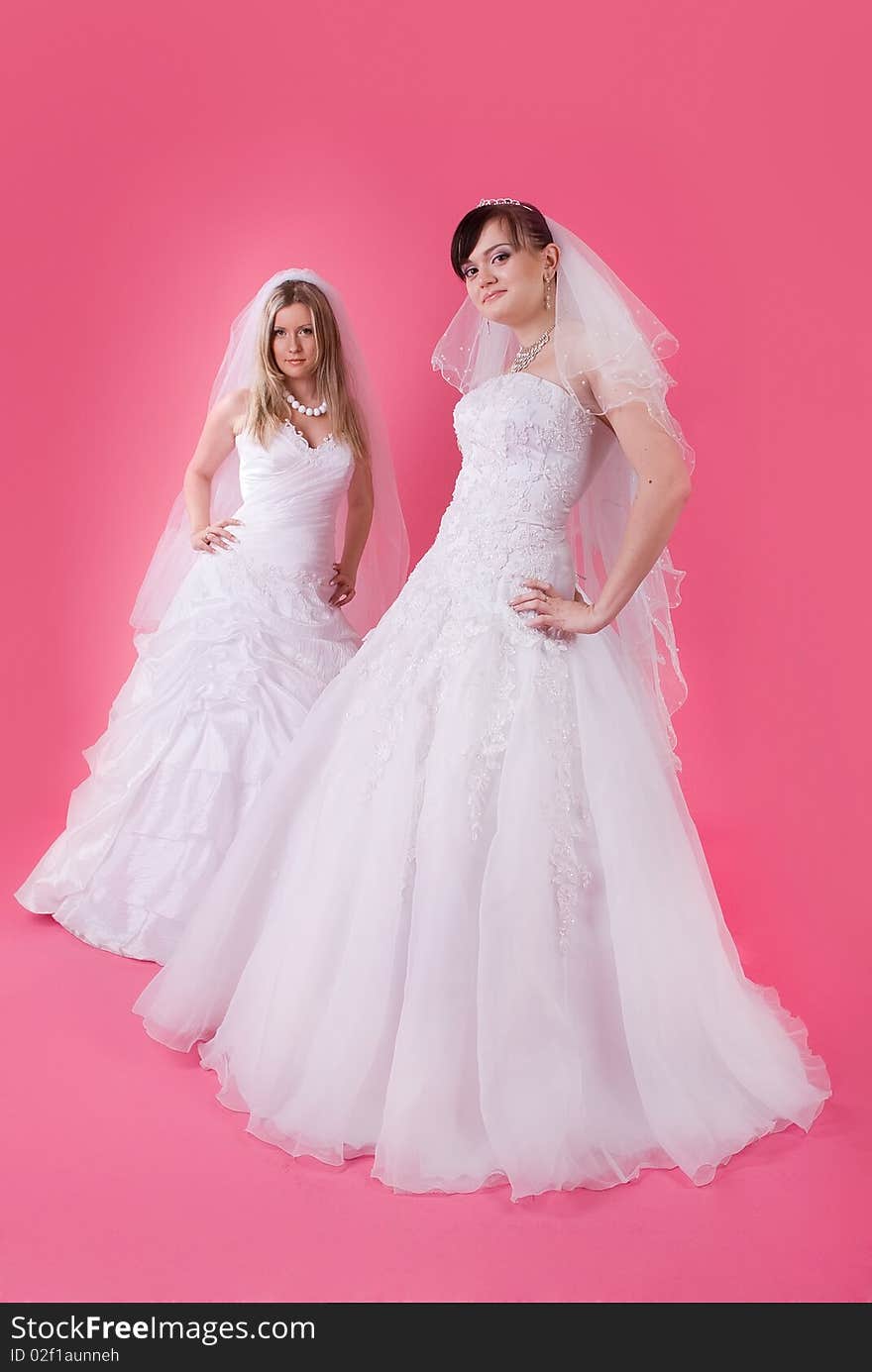 Two happy bride on a pink background