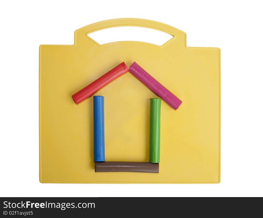 Moulding house on a yellow plate isolated on white. Moulding house on a yellow plate isolated on white.