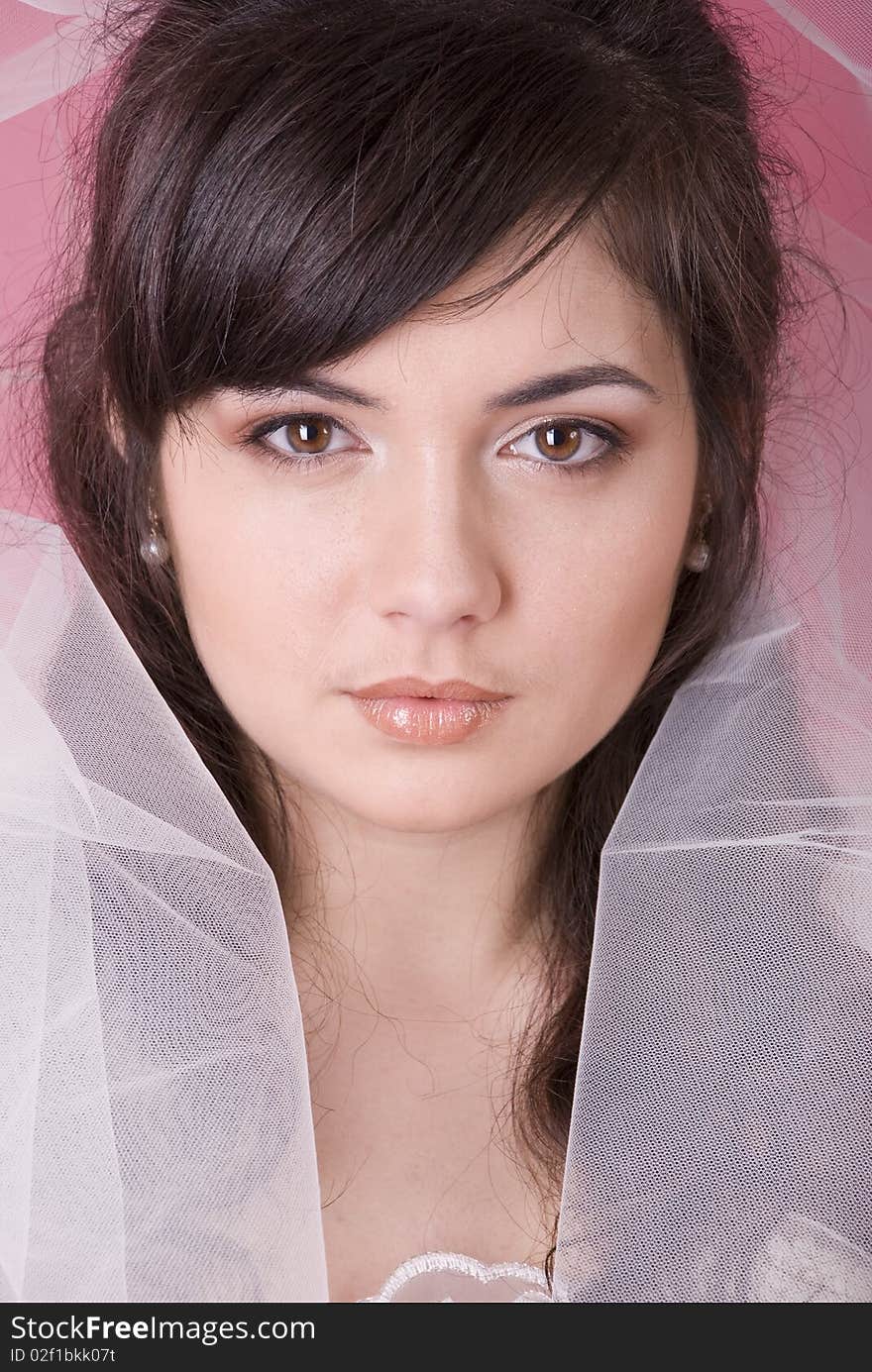 Studio portrait of a happy bride on a pink background