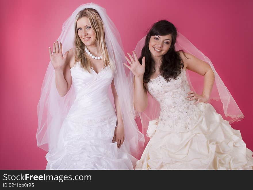 Two happy bride on a pink background