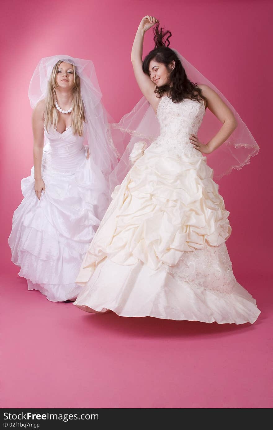 Two happy bride in studio