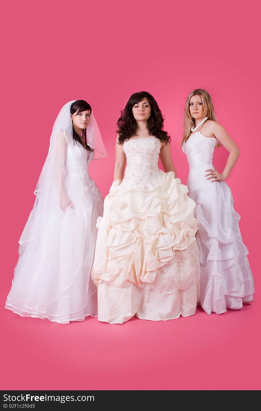 Three happy bride on a pink background