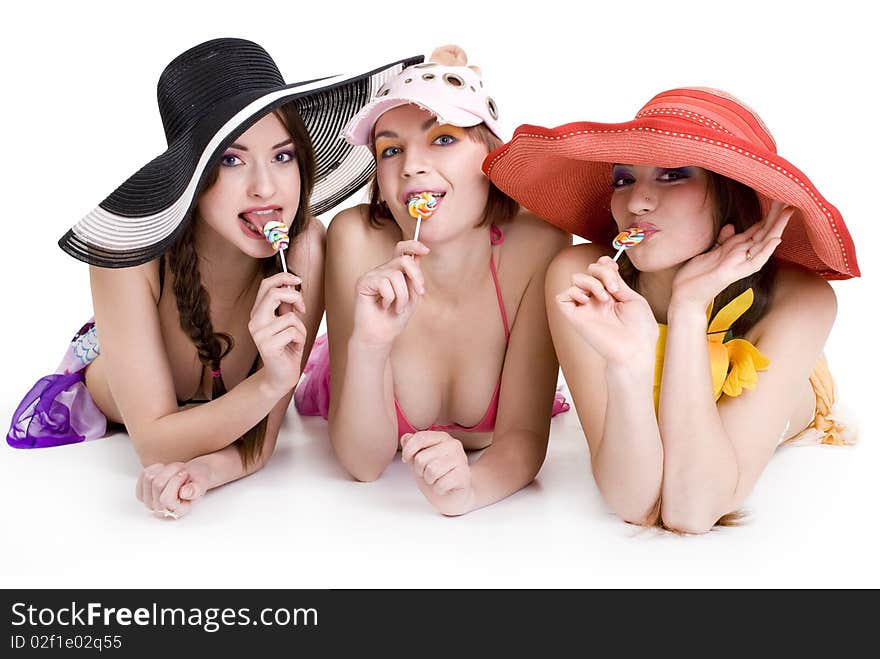 Three happy girls in a summer dress with candy. Three happy girls in a summer dress with candy