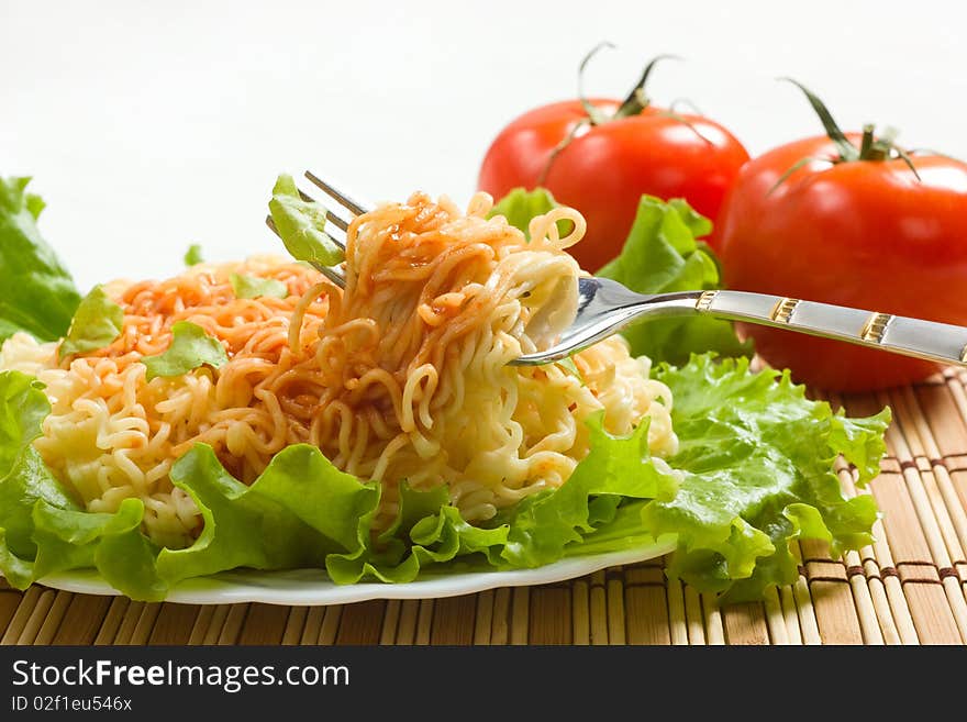 Dish of noodles on lettuce leaf