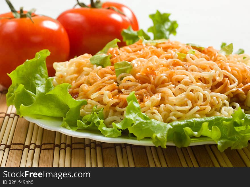 Dish of noodles on lettuce leaf