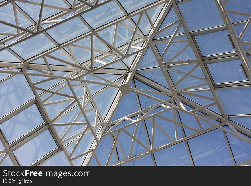 Contemporary roof structure with glass and clear blue sky