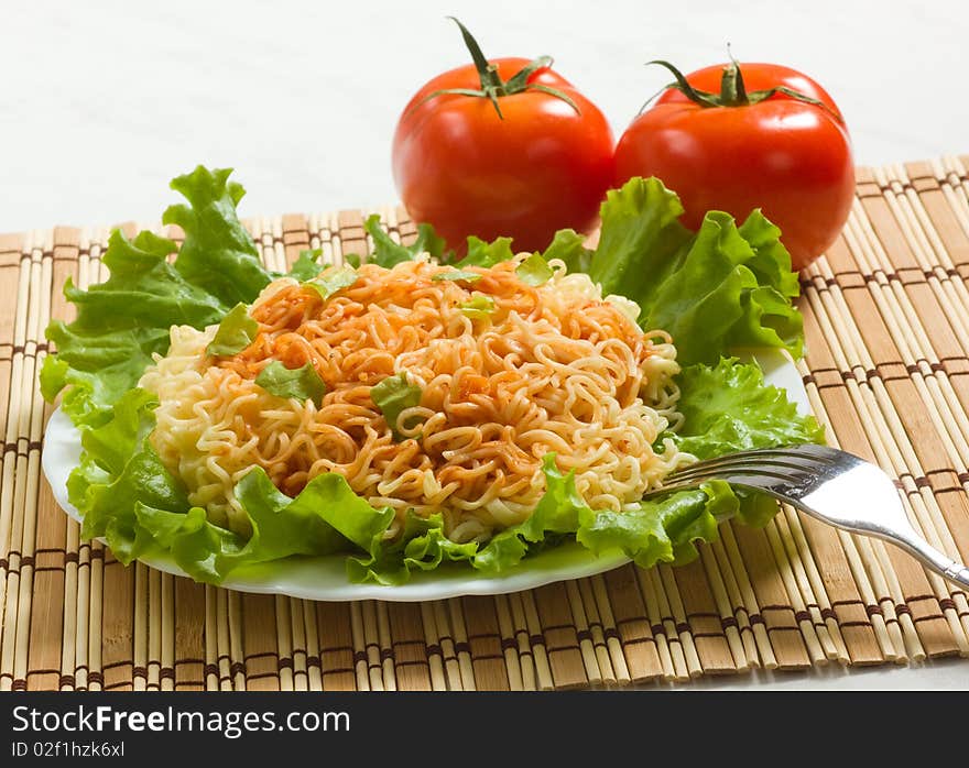 Dish of noodles on lettuce leaf