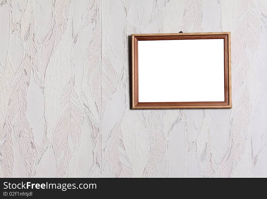 Simple wooden framework on a wall pasted over with wall-paper