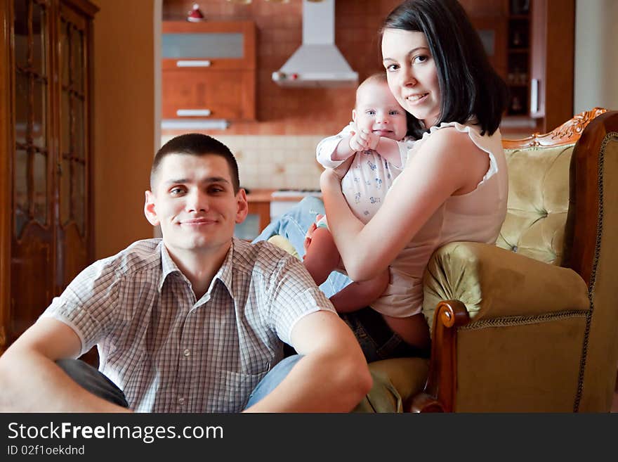 Adorable baby, father and mother in home. Adorable baby, father and mother in home